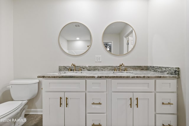 bathroom featuring hardwood / wood-style flooring, vanity, and toilet