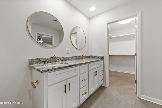 bathroom with ceiling fan, concrete flooring, and vanity