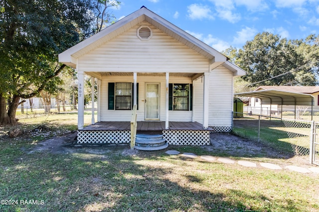 bungalow-style house with a carport, a front yard, and a porch