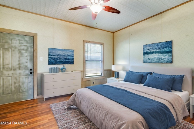 bedroom featuring ornamental molding, hardwood / wood-style floors, and ceiling fan