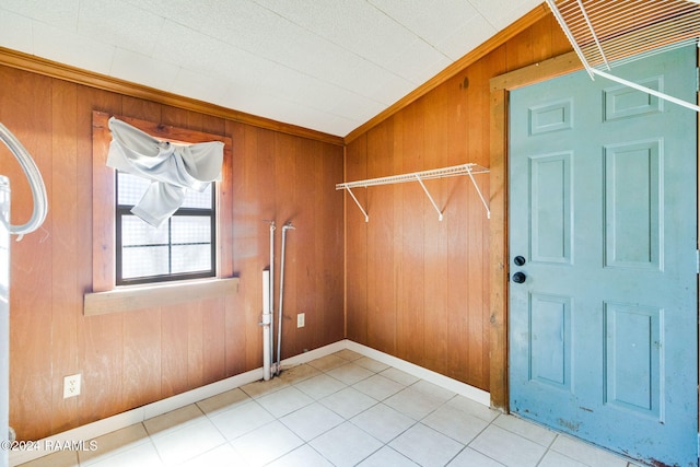 washroom featuring ornamental molding, wood walls, and tile patterned floors