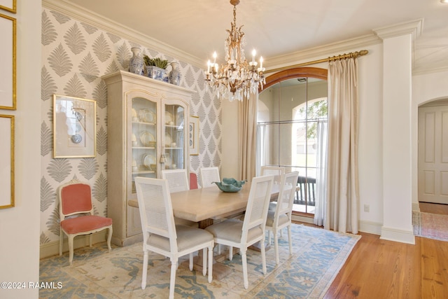 dining room featuring a chandelier, crown molding, and light hardwood / wood-style flooring