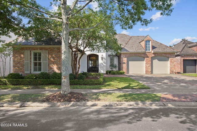 view of front facade with a front yard and a garage