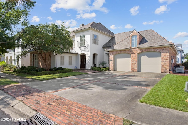 view of front facade with a balcony and a front lawn