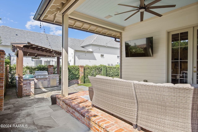 view of patio with an outdoor kitchen, a pergola, ceiling fan, and grilling area