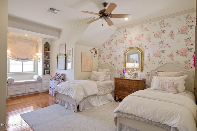 bedroom featuring ceiling fan, hardwood / wood-style flooring, and crown molding