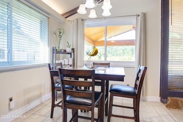 dining room with lofted ceiling, a chandelier, light tile patterned flooring, and a wealth of natural light