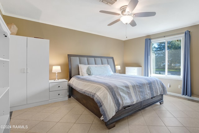 tiled bedroom with ceiling fan and ornamental molding