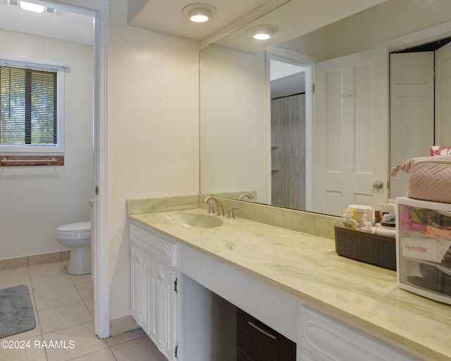 bathroom with vanity, toilet, and tile patterned floors