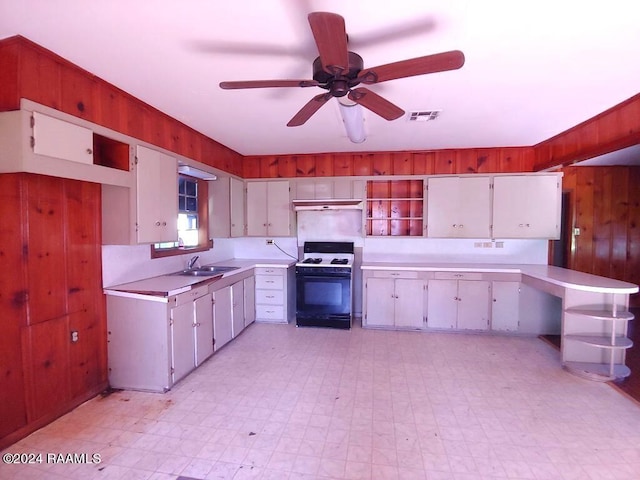 kitchen featuring white cabinetry, ceiling fan, white gas range oven, and sink