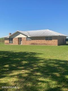 view of side of home with a lawn