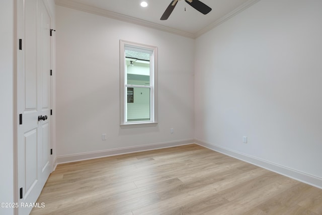 unfurnished bedroom featuring light wood-type flooring, a ceiling fan, baseboards, and crown molding