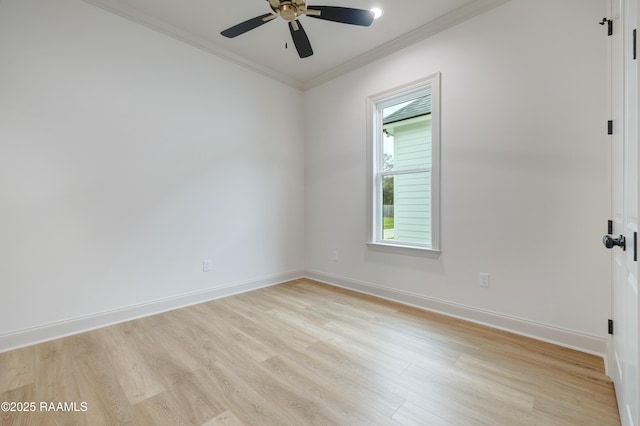 spare room with ornamental molding, ceiling fan, light wood-style flooring, and baseboards