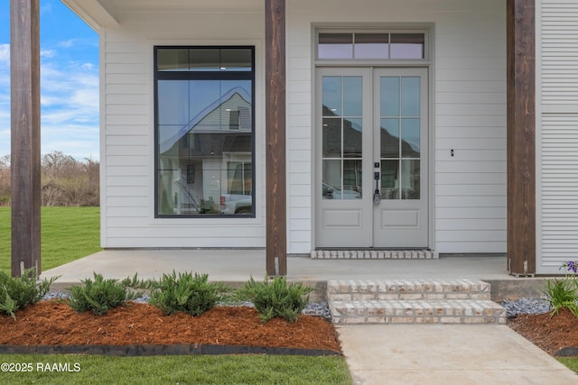 view of exterior entry featuring french doors