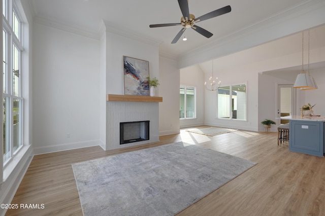 unfurnished living room featuring light wood-style flooring, a fireplace, baseboards, and crown molding