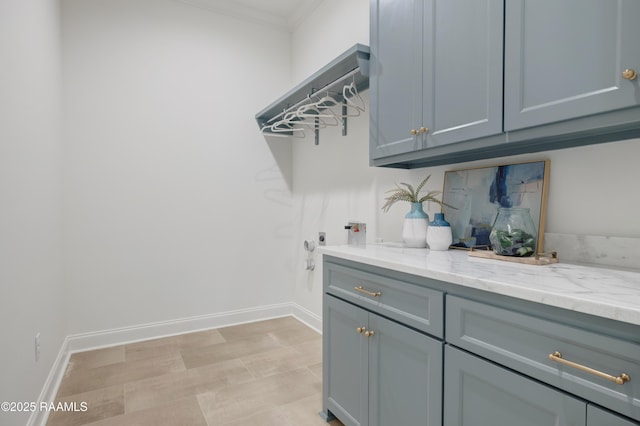 clothes washing area with gas dryer hookup, hookup for a washing machine, baseboards, cabinet space, and crown molding