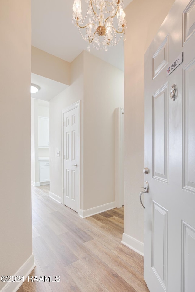 201 Settlers Trace Blvd Unit 2401, Lafayette, LA 70508 - hall with light wood-style flooring, a chandelier, and baseboards