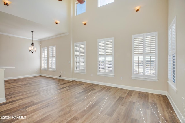 201 Settlers Trace Blvd Unit 2401, Lafayette, LA 70508 - unfurnished living room with a chandelier, wood finished floors, baseboards, ceiling fan, and ornamental molding