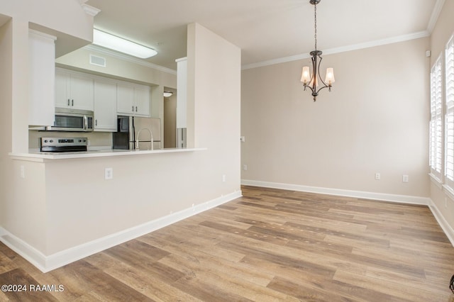 201 Settlers Trace Blvd Unit 2401, Lafayette, LA 70508 - kitchen featuring stainless steel appliances, crown molding, light wood-type flooring, baseboards, and a chandelier