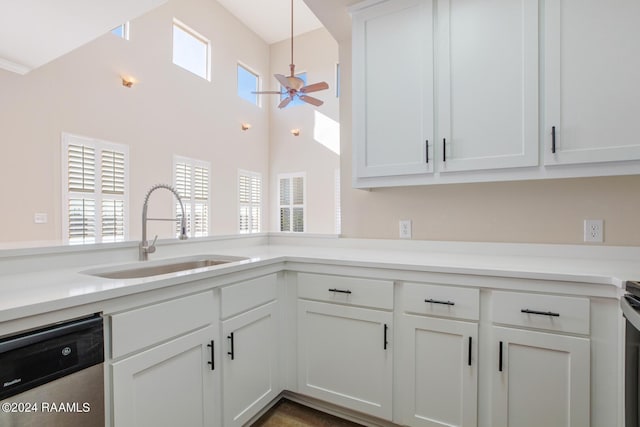201 Settlers Trace Blvd Unit 2401, Lafayette, LA 70508 - kitchen with stainless steel dishwasher, a sink, a ceiling fan, white cabinets, and a towering ceiling