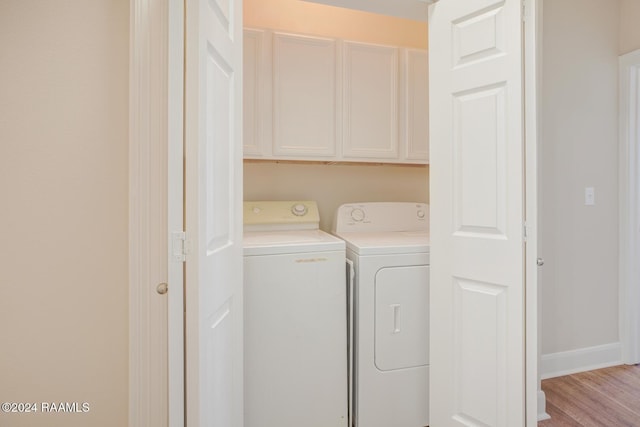 201 Settlers Trace Blvd Unit 2401, Lafayette, LA 70508 - laundry room featuring cabinet space, washer and dryer, wood finished floors, and baseboards