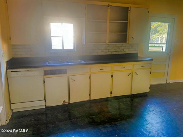 kitchen featuring a healthy amount of sunlight, sink, white dishwasher, and backsplash