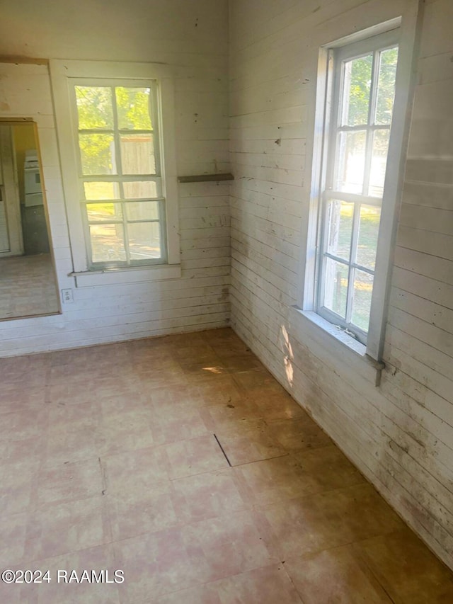 empty room featuring wooden walls