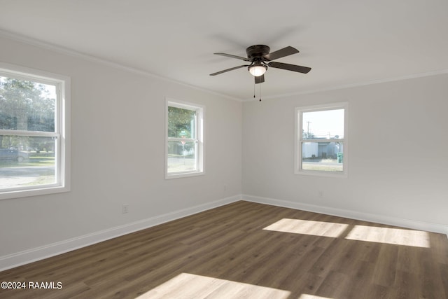 unfurnished room with ornamental molding, dark wood-type flooring, and a wealth of natural light