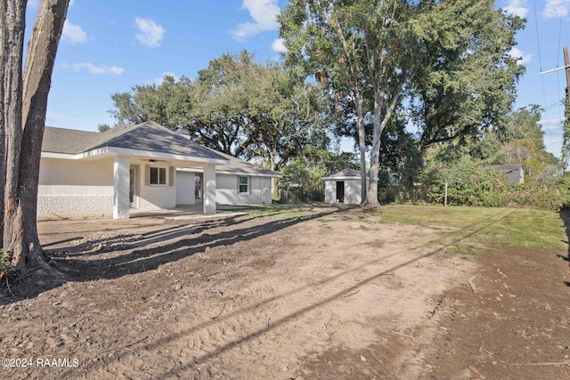 view of front of house featuring a shed