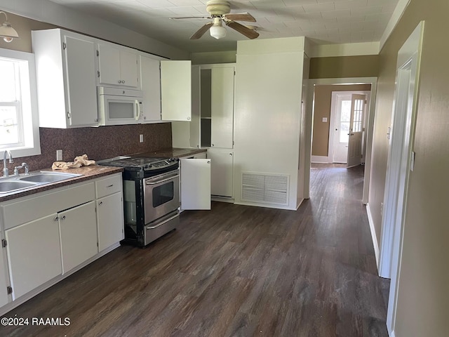 604 N Lejeune Ave, Kaplan, LA 70548 - kitchen featuring stainless steel range with gas stovetop, white microwave, a sink, ceiling fan, and dark wood finished floors