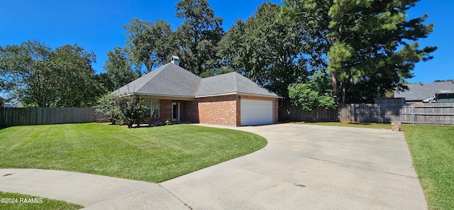 view of front of property with a front lawn and a garage