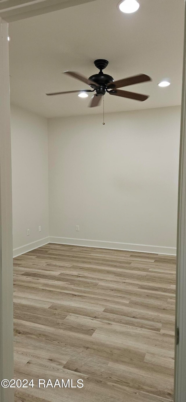 spare room with light hardwood / wood-style floors and ceiling fan