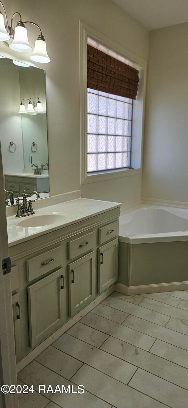 bathroom featuring vanity, a tub to relax in, and tile patterned flooring