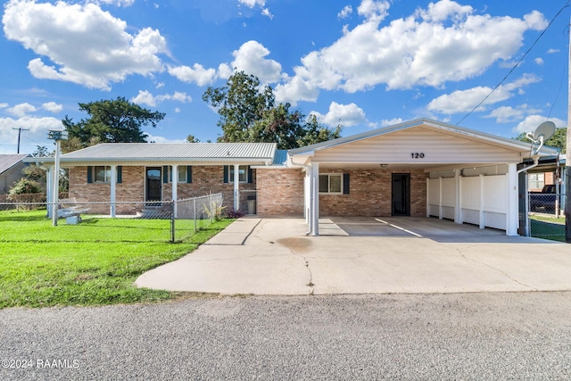 single story home with a front yard and a carport