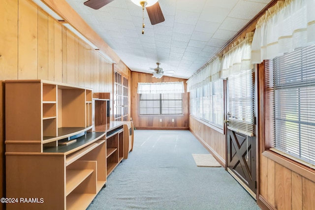 sunroom featuring ceiling fan and vaulted ceiling