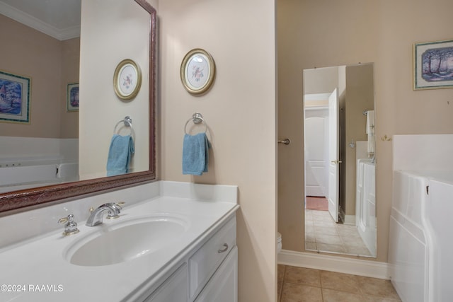 bathroom featuring vanity, toilet, ornamental molding, and tile patterned flooring