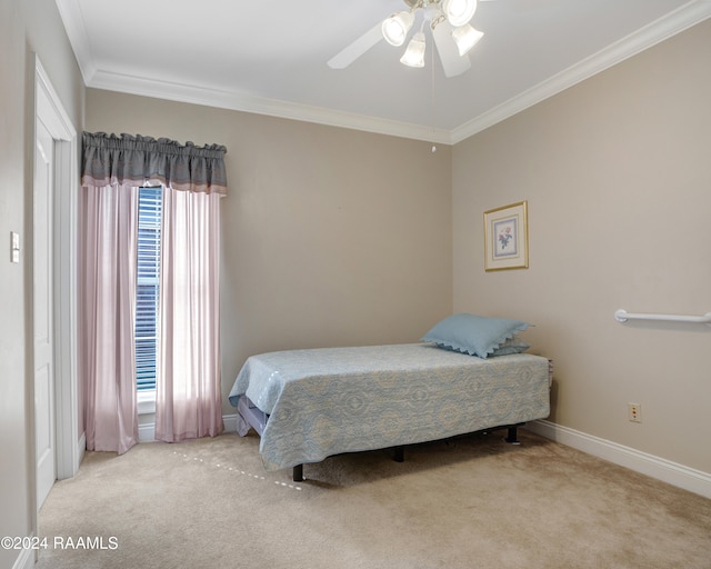 bedroom featuring carpet, crown molding, and ceiling fan