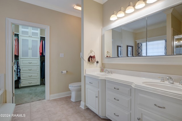 bathroom with vanity, ornamental molding, and toilet