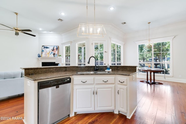 kitchen with white cabinetry, a kitchen island with sink, stainless steel dishwasher, and hanging light fixtures