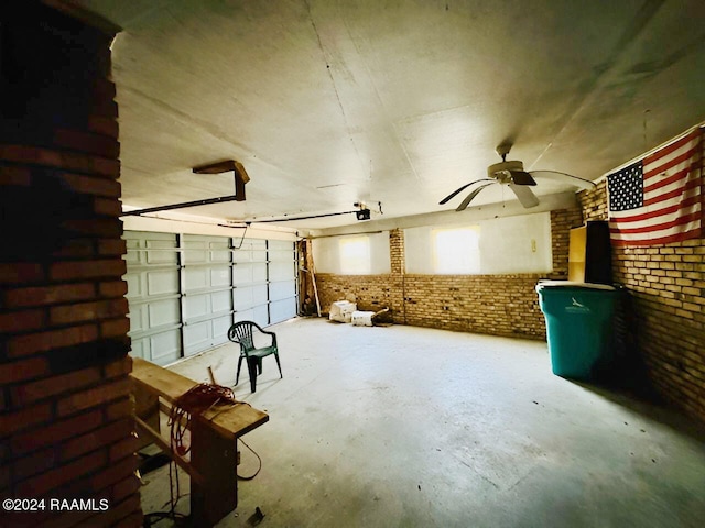 misc room with brick wall, concrete flooring, and ceiling fan