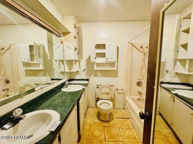 bathroom featuring a textured ceiling, double vanity, shower / bathing tub combination, and a sink