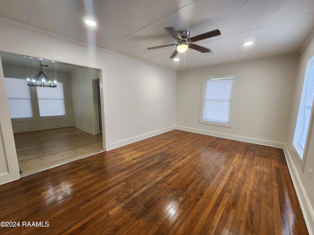 unfurnished room with ornamental molding, dark hardwood / wood-style floors, and ceiling fan with notable chandelier