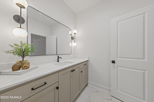 bathroom with baseboards, marble finish floor, and vanity