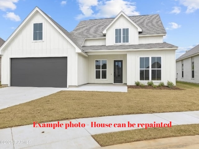 303 Decatur Ln, Lafayette, LA 70503 - modern inspired farmhouse featuring driveway, a front yard, roof with shingles, a garage, and board and batten siding