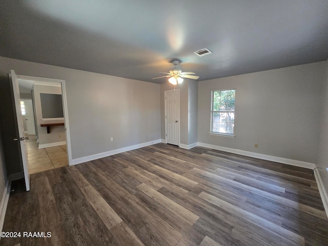 unfurnished bedroom with ceiling fan and dark hardwood / wood-style floors