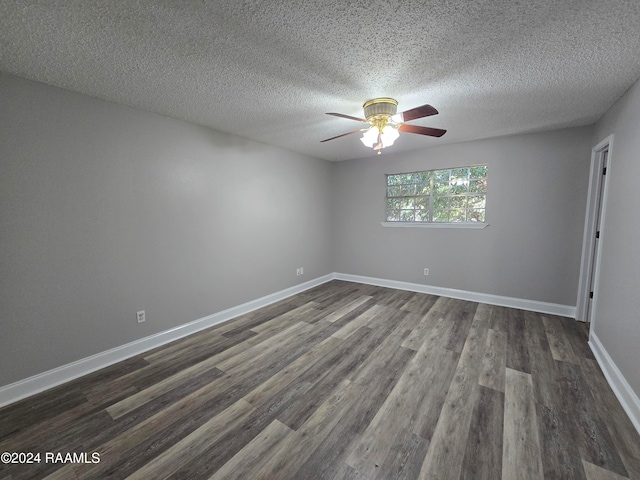 empty room featuring dark hardwood / wood-style floors, a textured ceiling, and ceiling fan