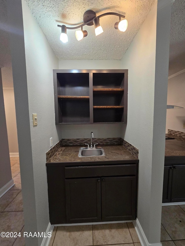 bathroom featuring vanity, a textured ceiling, and tile patterned flooring