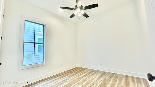 empty room featuring ceiling fan, light wood-type flooring, and ornamental molding