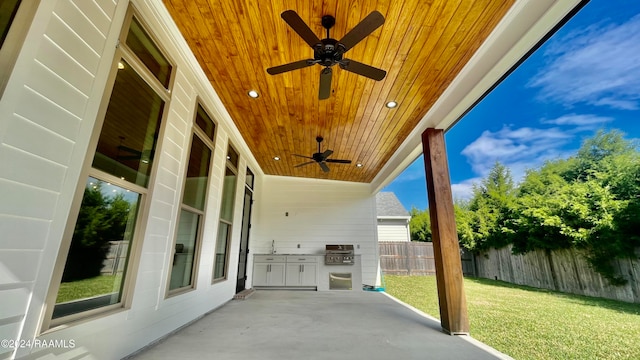 view of patio with ceiling fan and a grill