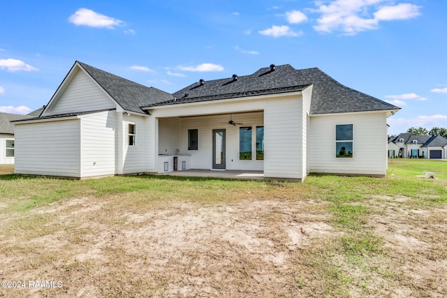 back of house featuring ceiling fan, a patio area, and a lawn